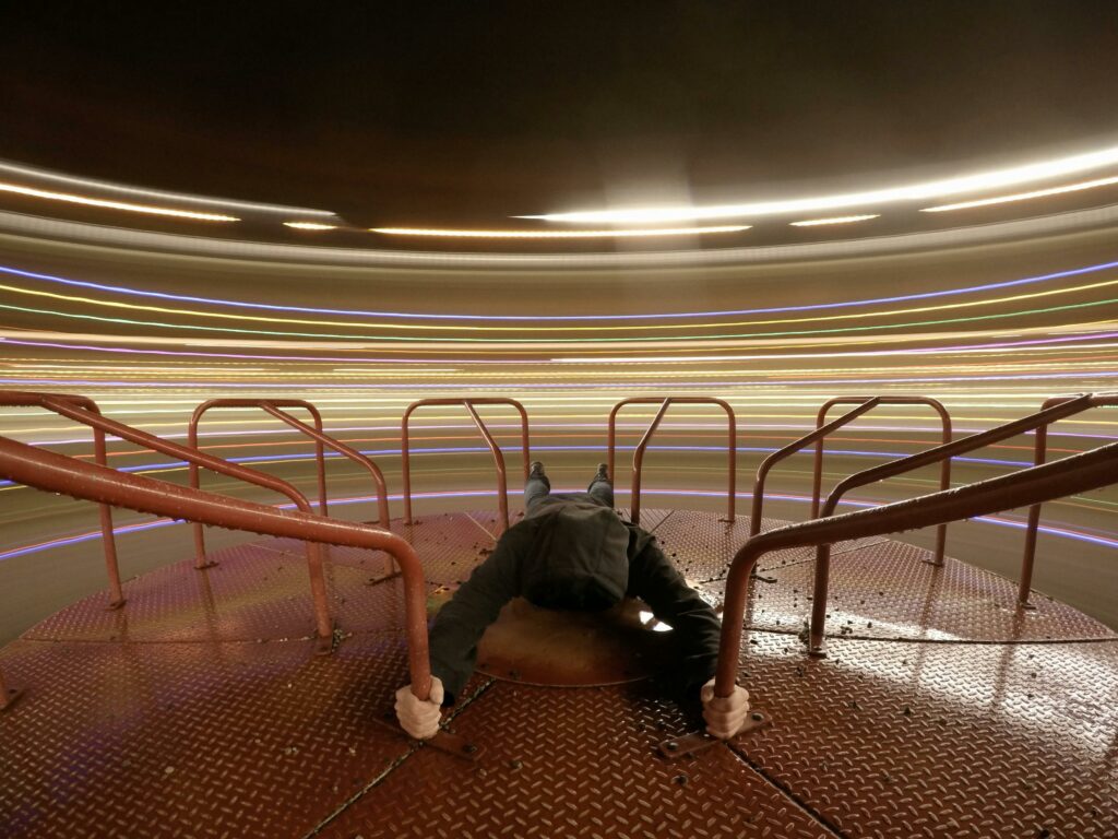 Stunning long exposure captures colorful motion on a playground, creating vibrant light trails.